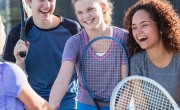 Teens laughing playing tennis