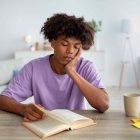 Teen looking glum whilst reading